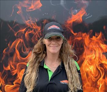 Female standing against fake fire backdrop 