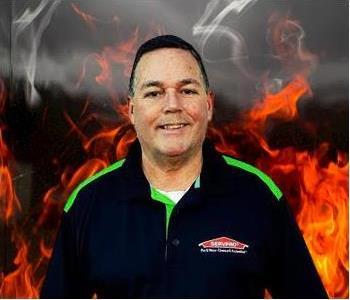 male employee photo, smiling and standing in black SERVPRO shirt
