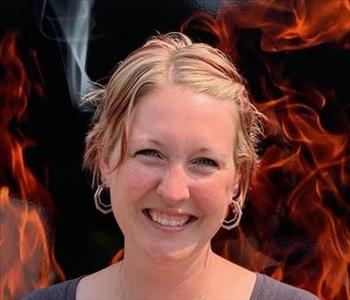 smiling woman against faux fire backdrop