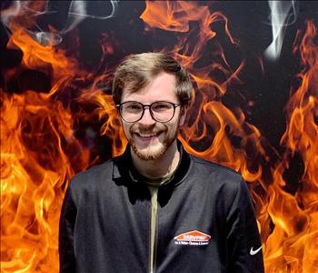 smiling man against faux fire backdrop