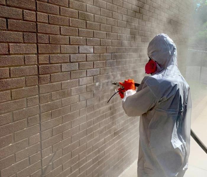 Soda blasting spray paint off a brick wall
